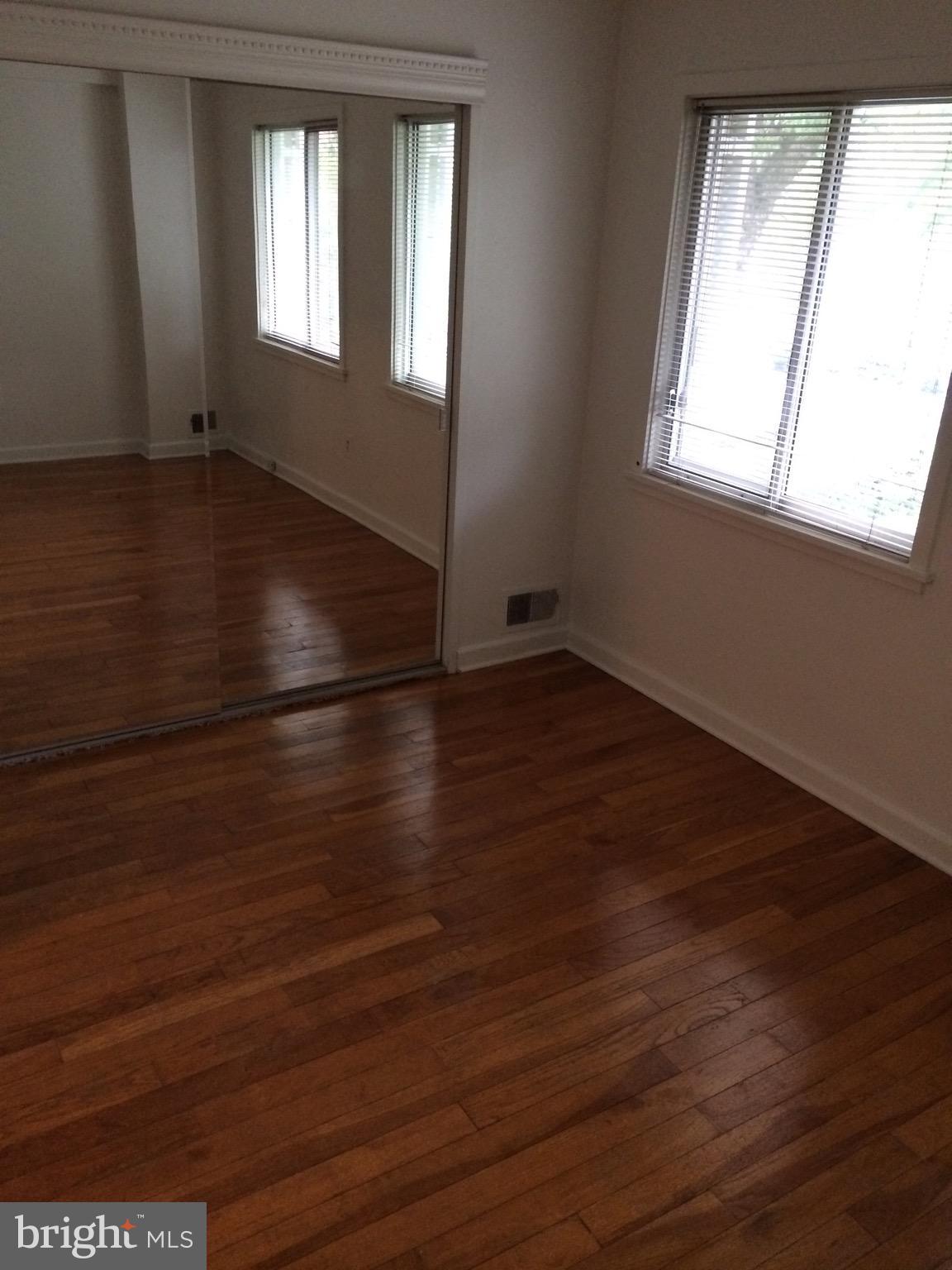 803 3rd Street Southwest, Unit 706 Washington, DC 20024 - Photo 9 of 18 an empty room with wooden floor and windows