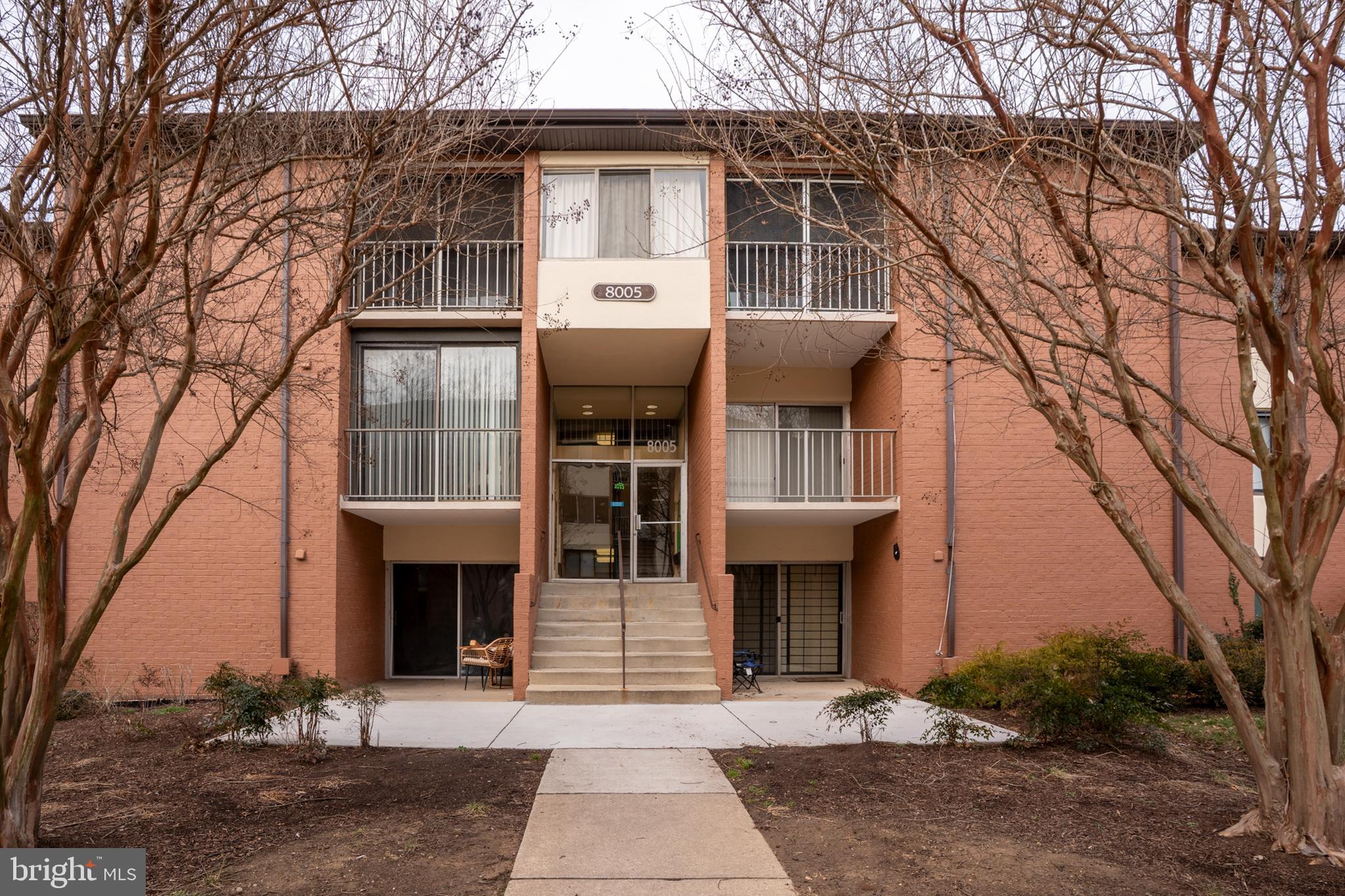 8005 Mandan Road, Unit 302 Greenbelt, MD 20770 - Photo 2 of 22 a front view of a house with yard