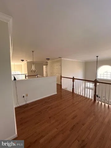 a view of a kitchen with wooden floor and stairs