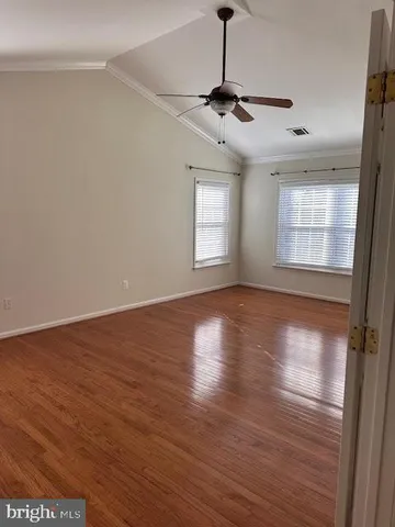 a view of wooden floor and windows in a room