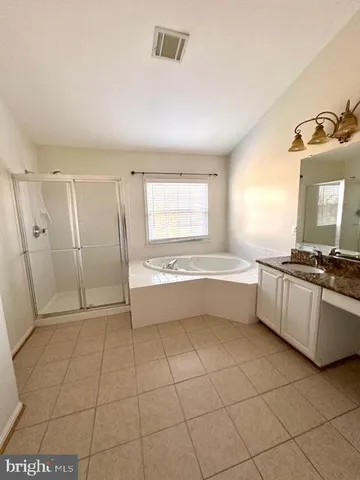 a large white kitchen with a sink a stove and a window