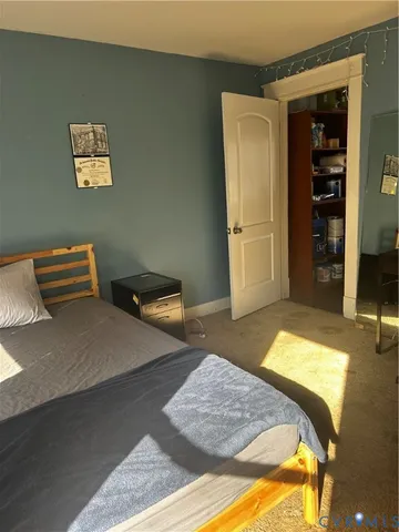 a bedroom with a bed and a walk in closet