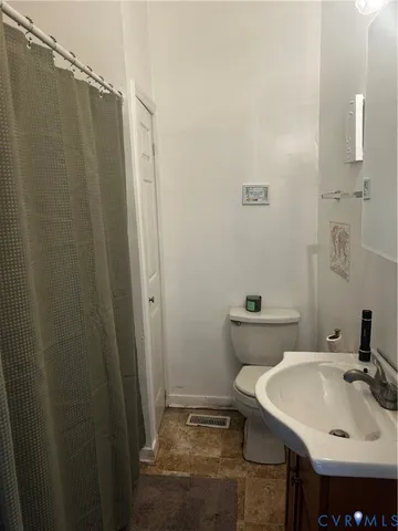 a bathroom with sink a mirror a toilet and vanity