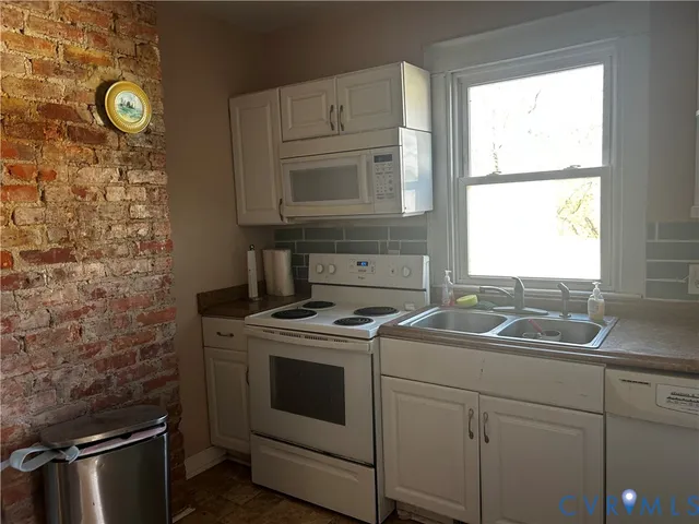 a kitchen with a stove sink and window