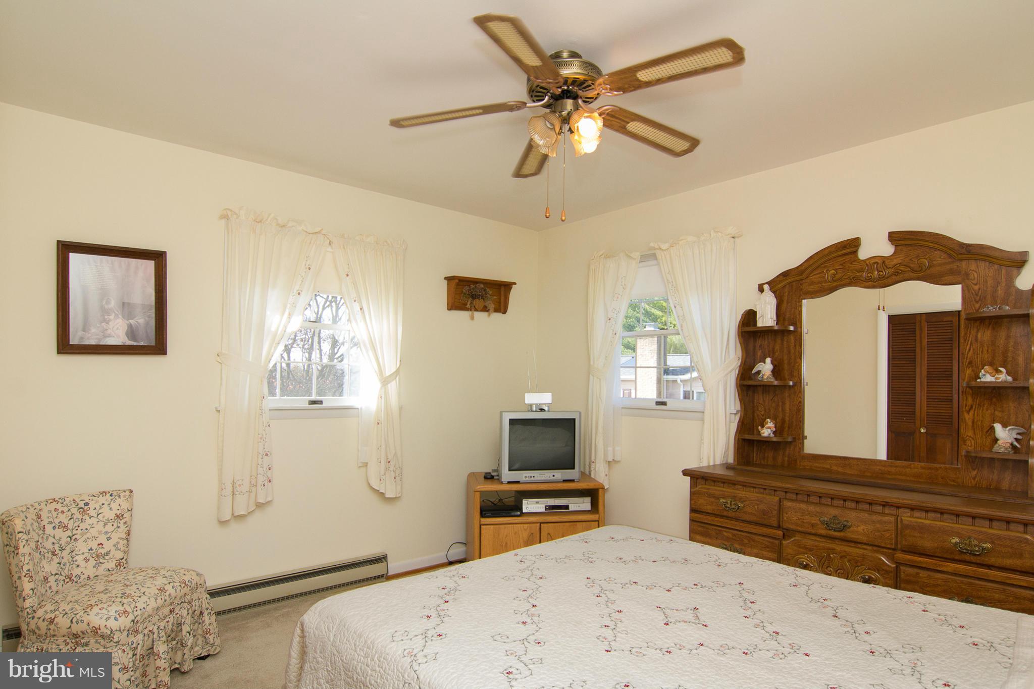 2514 Neudecker Road Westminster, MD 21157 - Photo 13 of 30 a bedroom with a bed a mirror on the wall and a large window