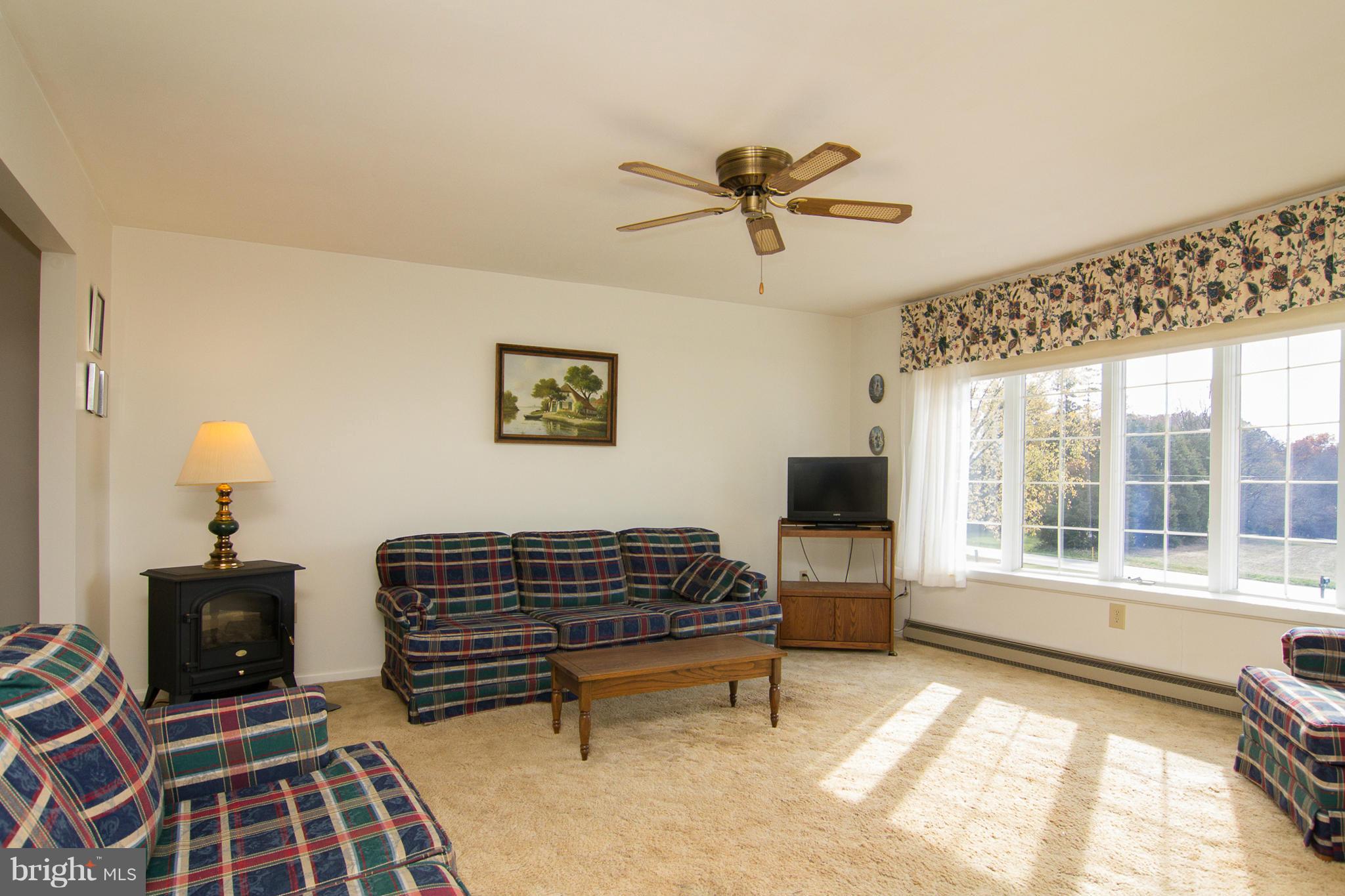 2514 Neudecker Road Westminster, MD 21157 - Photo 4 of 30 a living room with furniture a fireplace and a flat screen tv