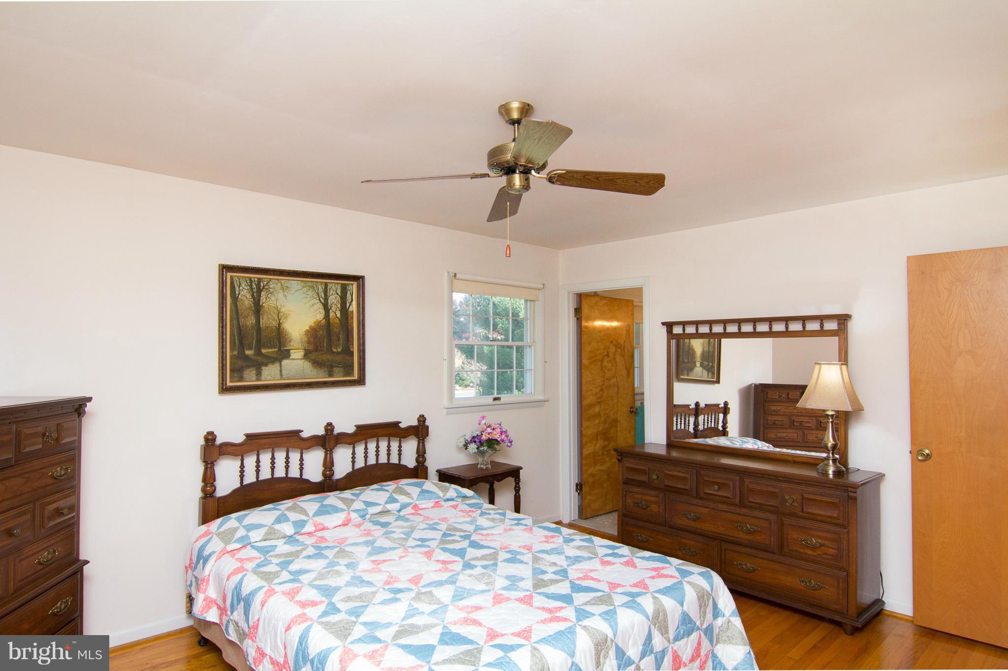 2514 Neudecker Road Westminster, MD 21157 - Photo 10 of 30 a bedroom with a bed and wooden floor