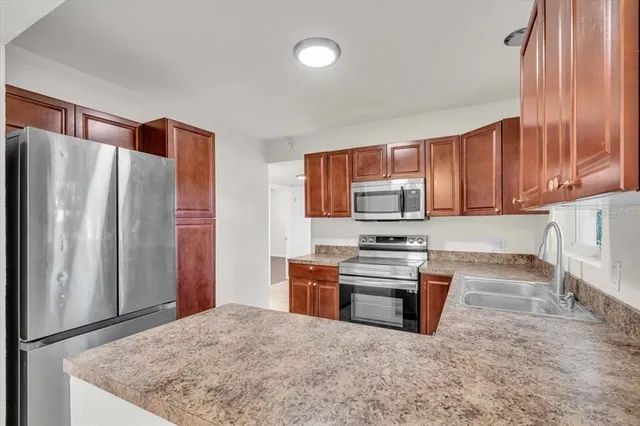 a kitchen with a sink and a refrigerator