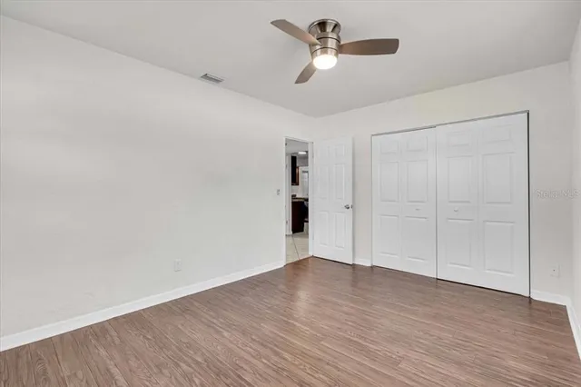 a view of a storage & utility room with refrigerator and a kitchen