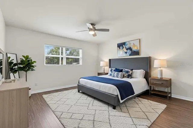 a bedroom with a large bed and a window