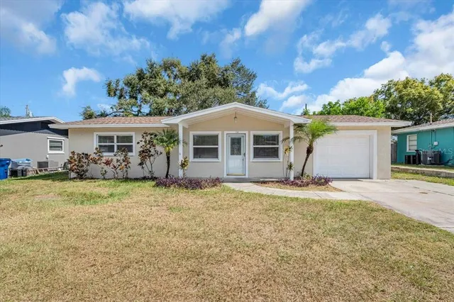 a front view of a house with a garden