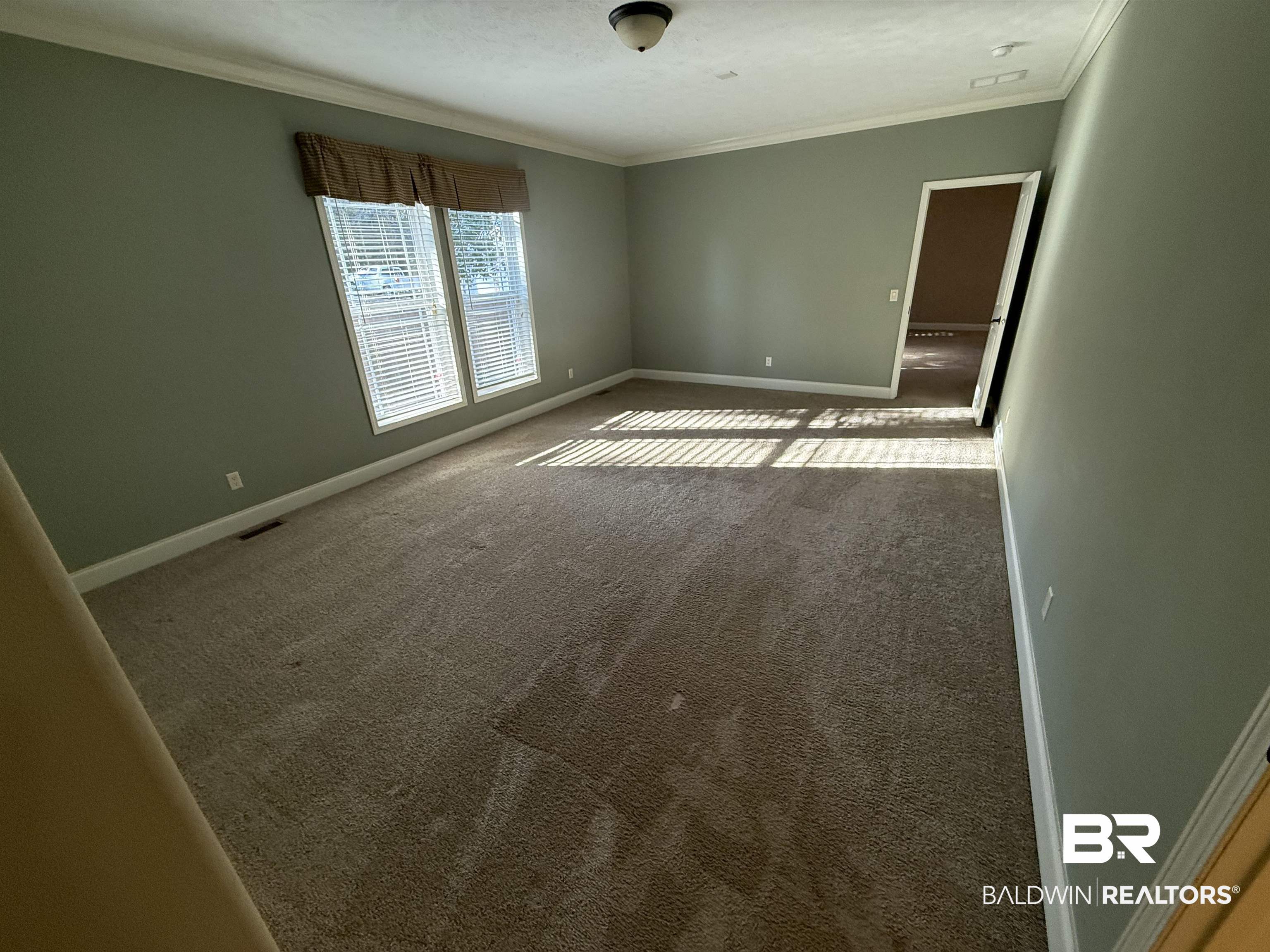 1274 Caney Loop Lillian, AL 36549 - Photo 11 of 19 Unfurnished room featuring carpet and ornamental molding