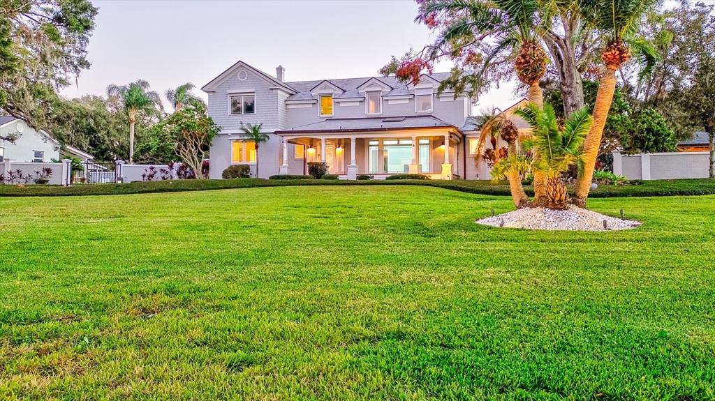 518 Riverside Drive Tarpon Springs, FL 34689 - Photo 4 of 82 a front view of a house with a garden