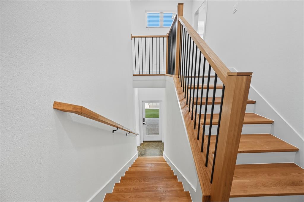 100 Cardinal Wds Granbury, TX 76049 - Photo 15 of 36 Stairs with wood finished floors and a towering ceiling