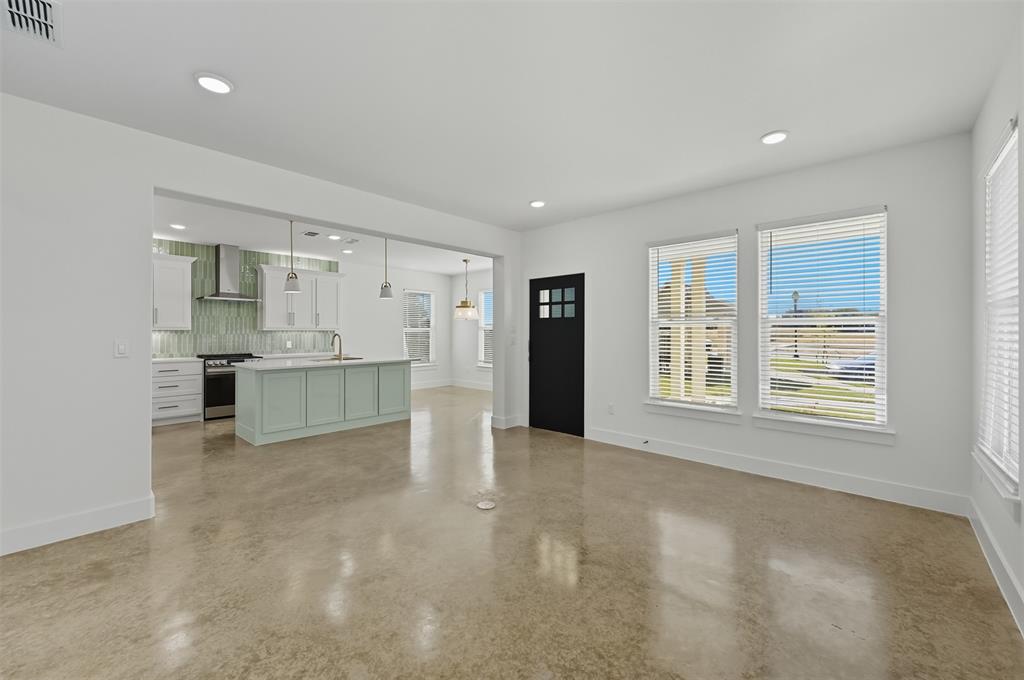 100 Cardinal Wds Granbury, TX 76049 - Photo 5 of 36 Unfurnished living room featuring plenty of natural light, recessed lighting, and concrete floors