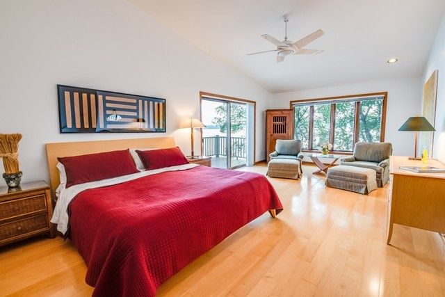 a bedroom with a large bed and a couch