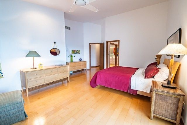 a bedroom with furniture and a lamp