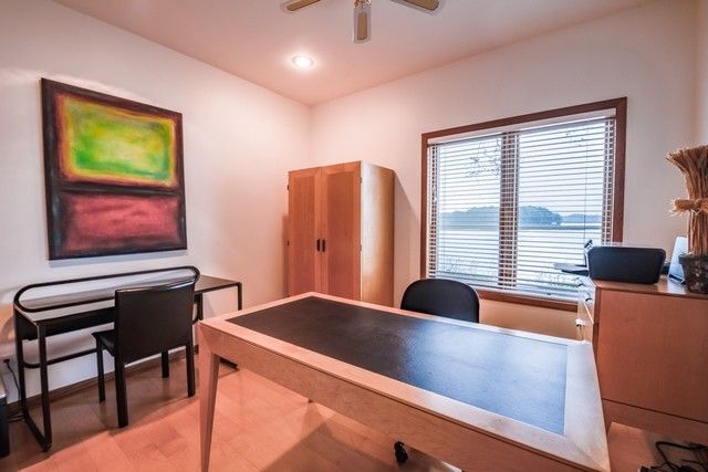 a view of a workspace with furniture and a window