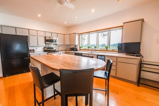 a dining table chair next to a window