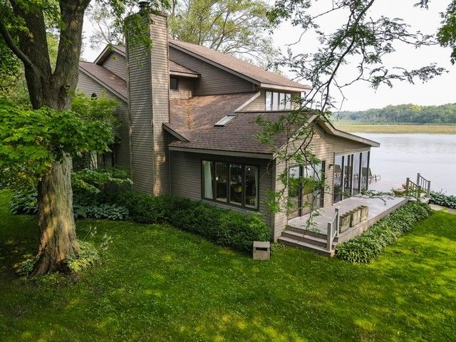 a view of a house with a yard and sitting area