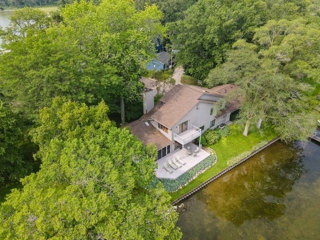 an aerial view of a house with a yard