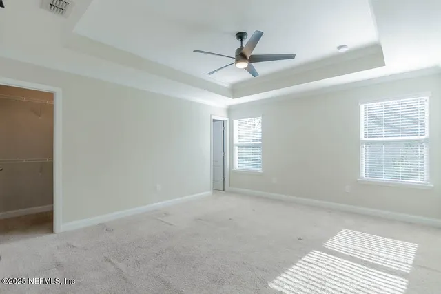 a view of a livingroom with a ceiling fan and window