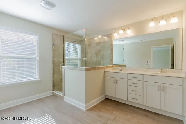 a bathroom with a double vanity sink and mirror
