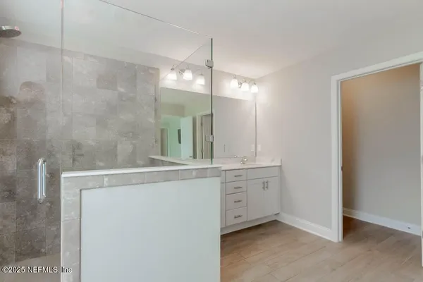 a view of a bathroom with a sink and mirror