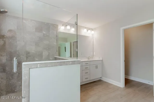 a view of a bathroom with a sink and mirror
