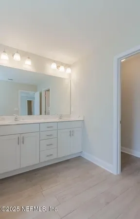 a bathroom with a granite countertop sink and mirror