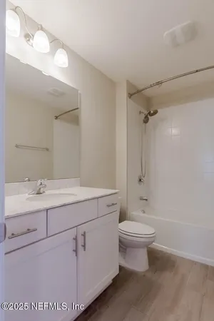 a bathroom with a double vanity sink toilet and shower