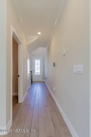 a view of a hallway with wooden floor
