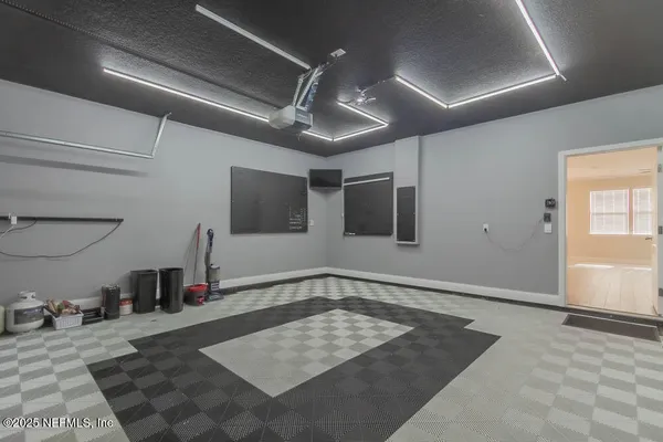 a view of a hallway with a projector and furniture