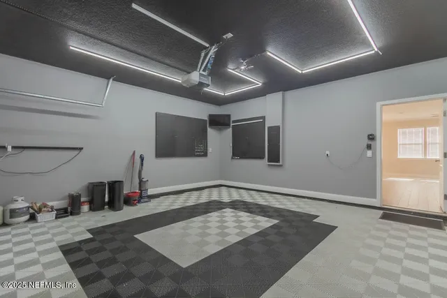 a view of a hallway with a projector and furniture