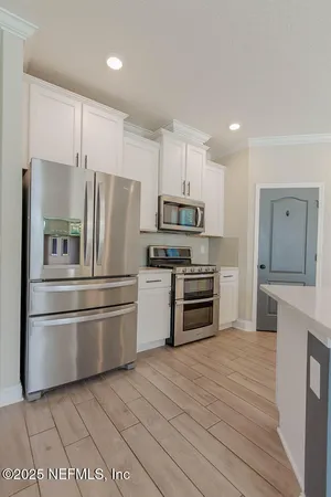 a kitchen with granite countertop a refrigerator and a stove