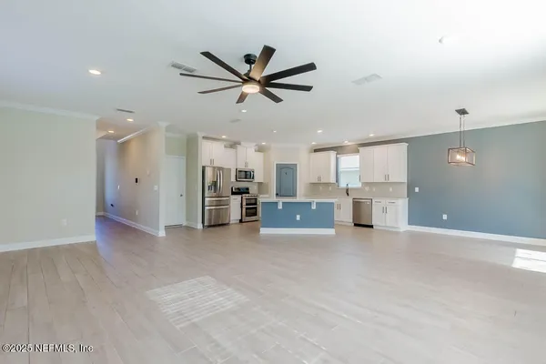 a view of a kitchen with a sink and a window
