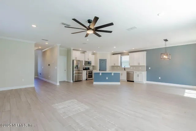 a view of a kitchen with a sink and a window