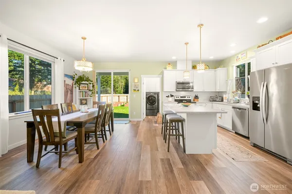 a view of kitchen with refrigerator a sink and wooden floor