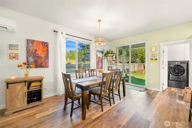 a dining room with furniture a chandelier and wooden floor