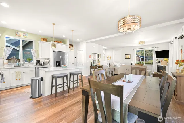 a view of kitchen and dining area with a table chairs