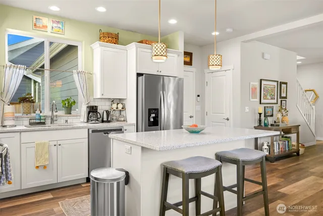 a large kitchen with a table and chairs