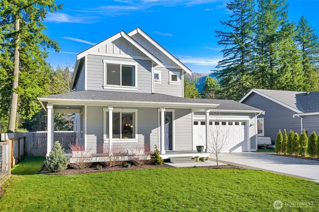 a front view of a house with a yard and porch