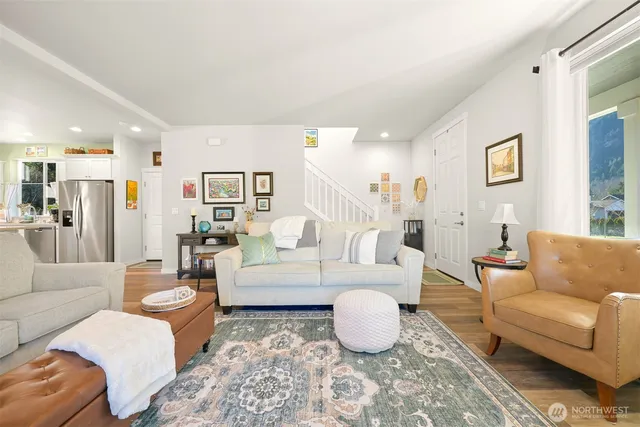 a living room with furniture a rug and a table