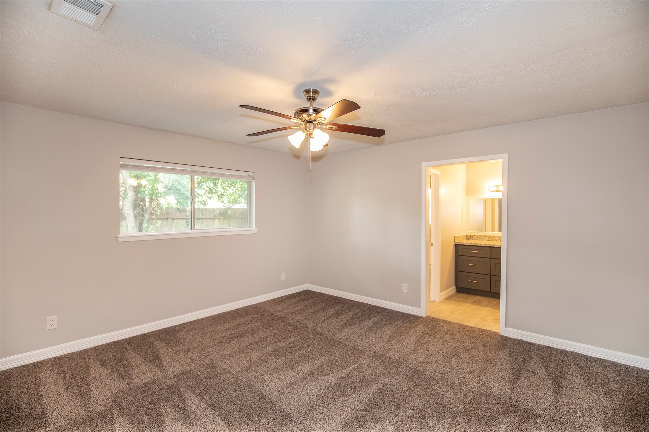802 Wavecrest Lane Houston, TX 77062 - Photo 15 of 32 Huge primary bedroom with beatuiful carpet flooring and a lovely ceiling fan.