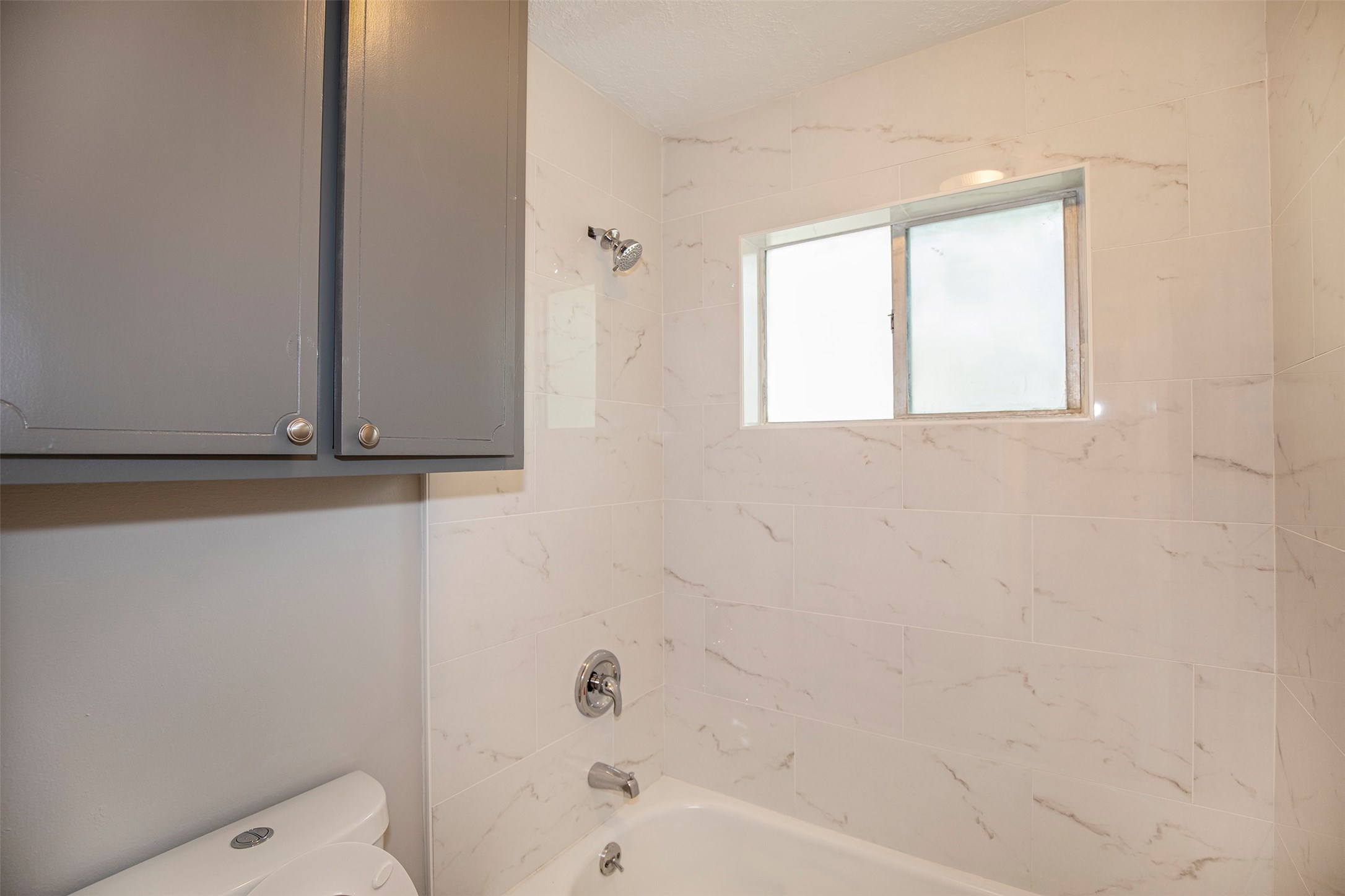 802 Wavecrest Lane Houston, TX 77062 - Photo 22 of 32 The guest bathroom has a wonderful cabinet to store towels and other necessities.