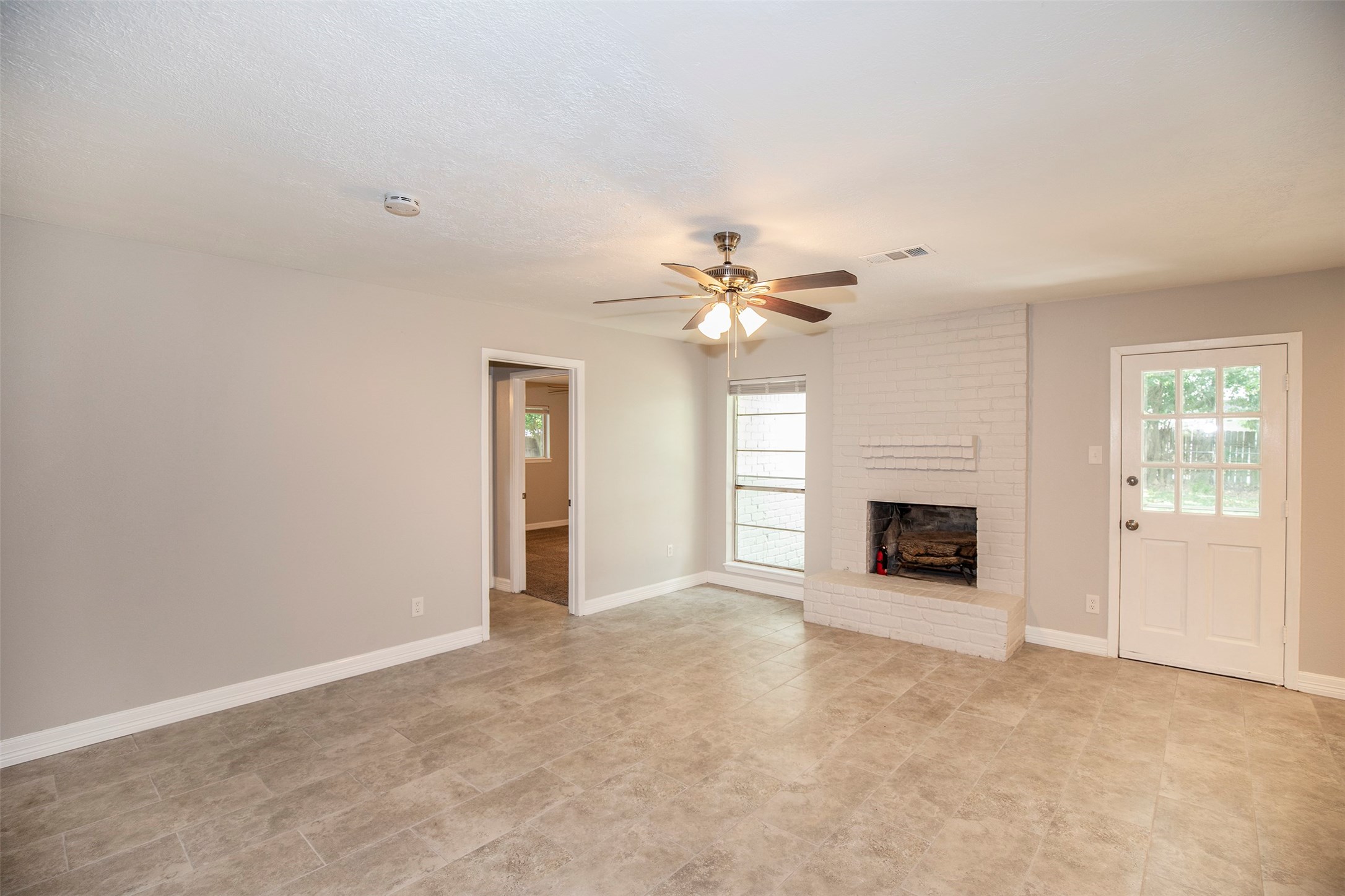 802 Wavecrest Lane Houston, TX 77062 - Photo 6 of 32 Sapcious family room with a wonderful fireplace and updated ceiling fan.