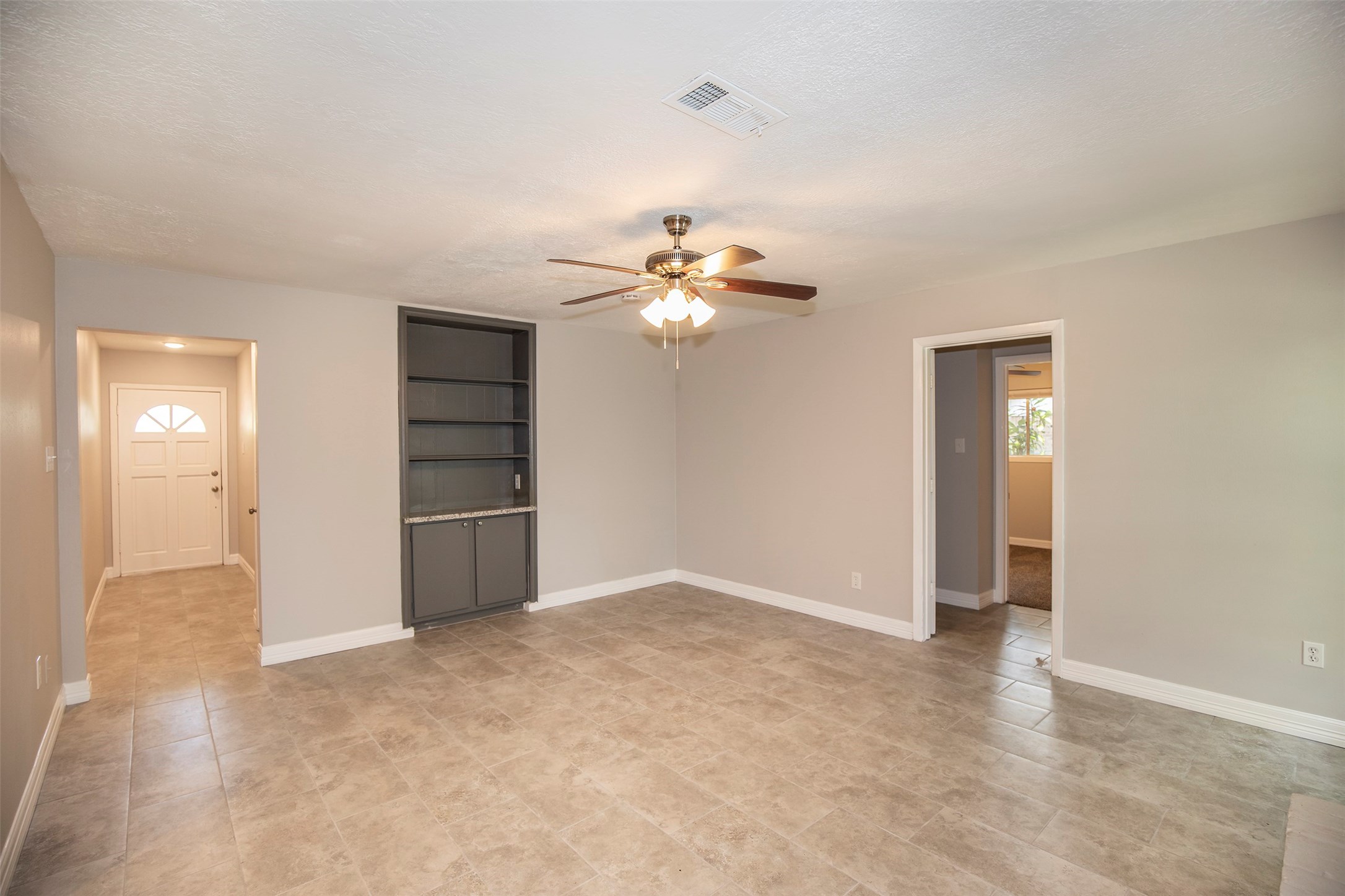 802 Wavecrest Lane Houston, TX 77062 - Photo 7 of 32 From this view of the family room you can see the entryway and a fabulous built-in bookshelf.