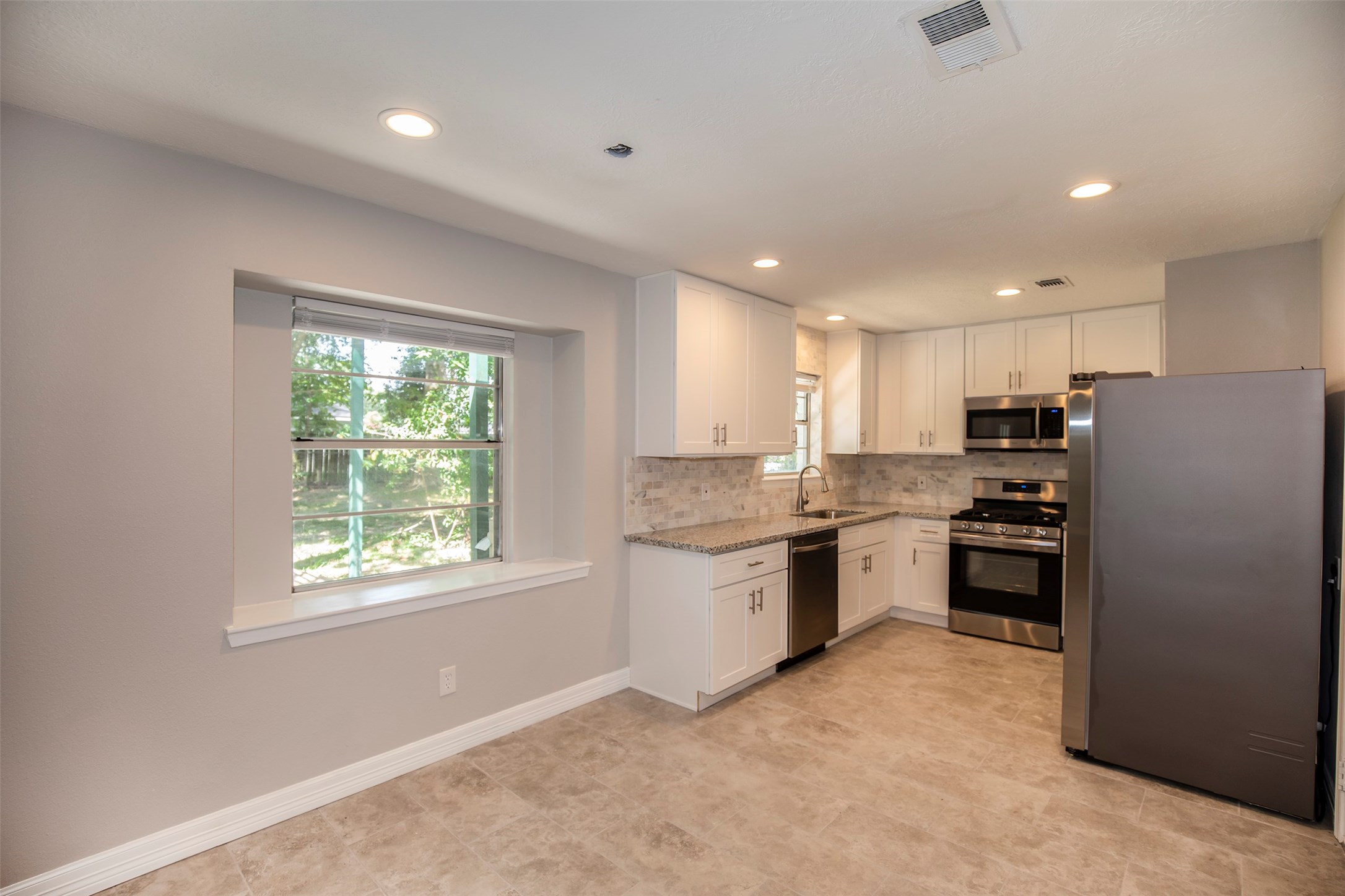 802 Wavecrest Lane Houston, TX 77062 - Photo 10 of 32 The dining area features recessed lighting and a window with a large ledge.