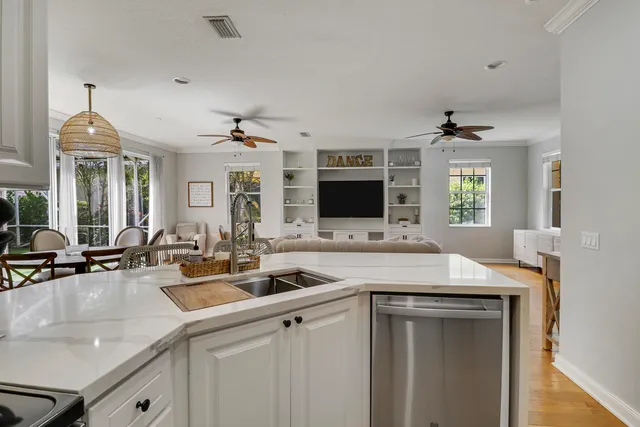 a kitchen with stainless steel appliances a sink stove and cabinets