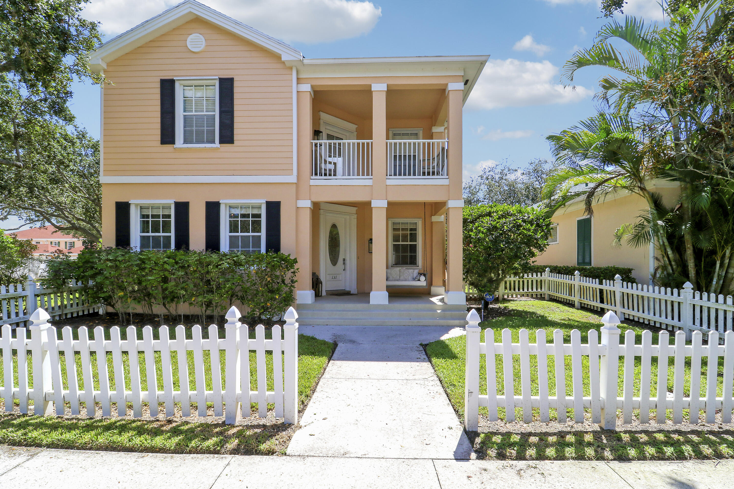 131 Rockingham Road Jupiter, FL 33458 - Photo 2 of 40 a front view of a house with a garden and plants